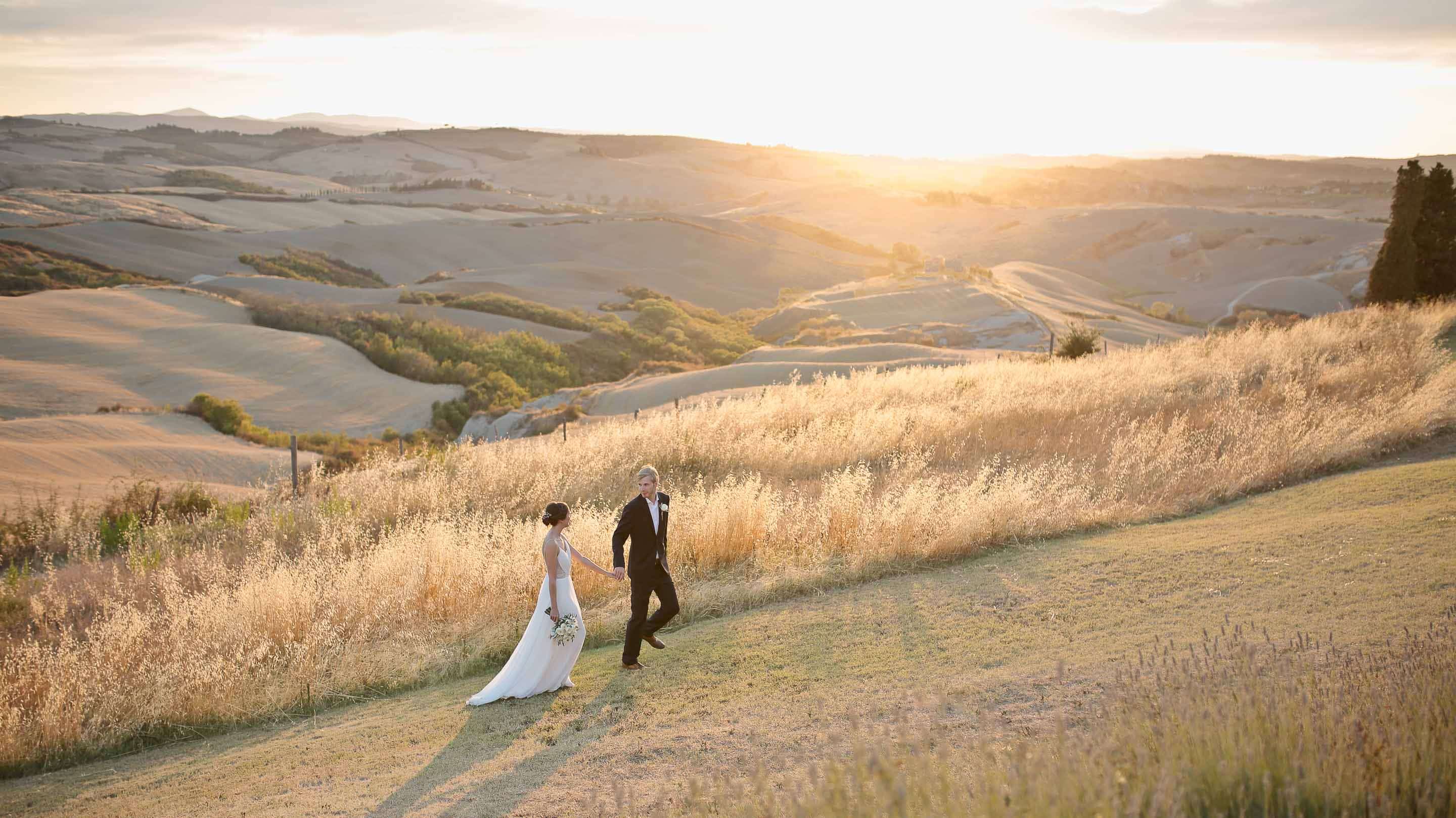 newlyweds walk happy in the countryside of the lazy olive