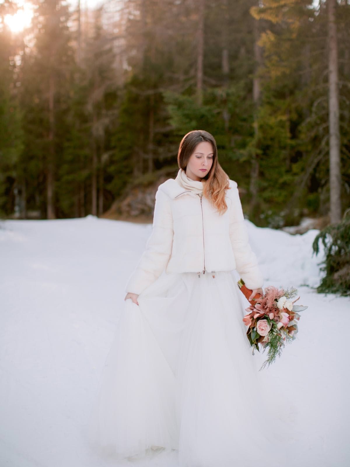 bride on the snow for this intimate winter wedding by the Dolomites
