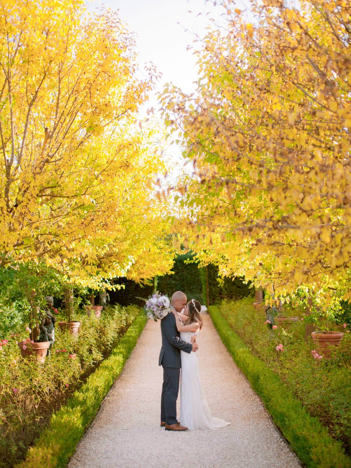 Bride and groom in the middle of Borgo Santo Pietro gardens